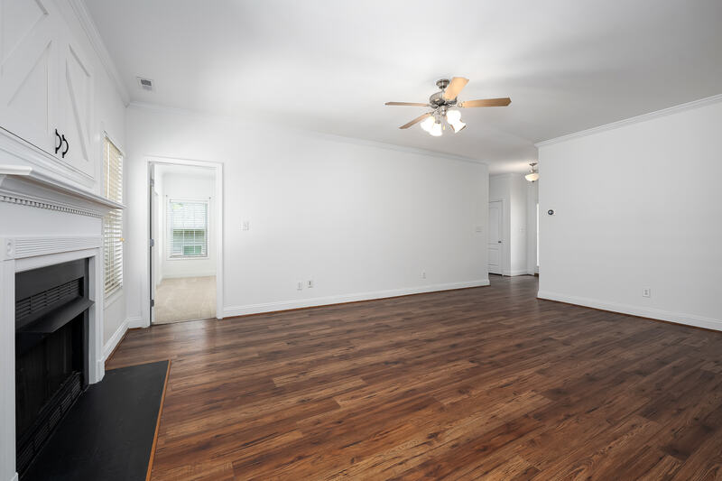 Great room with the fireplace and hallway beyond
