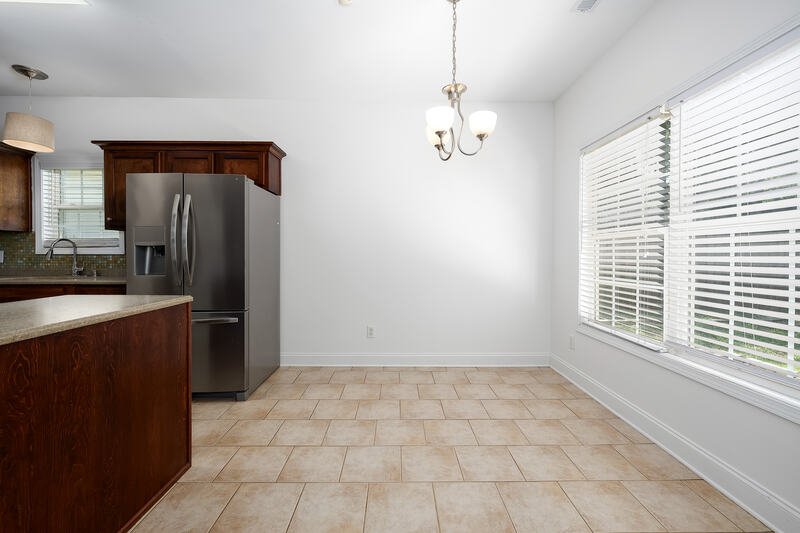 Kitchen and bright eating area with a chandelier