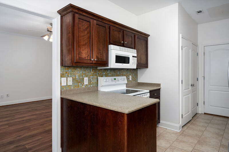 Kitchen with a peninsula and mosaic tile backsplash