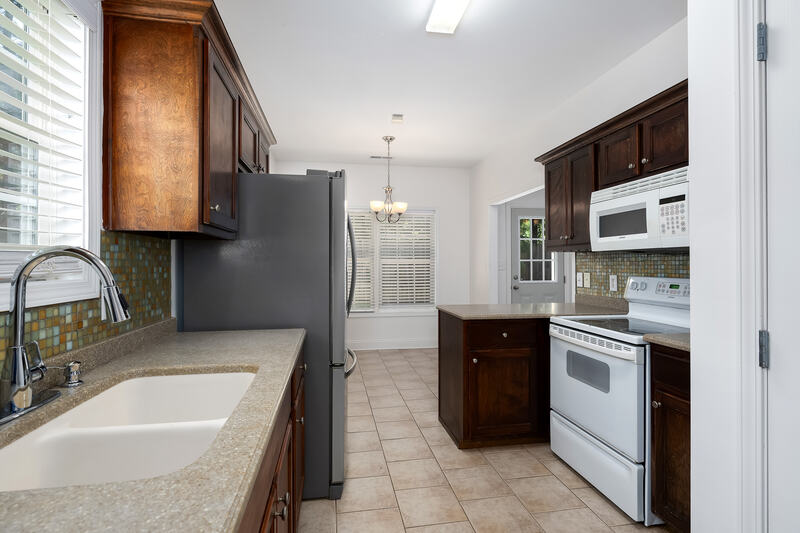 Kitchen with a sink under the window and views to the eating area