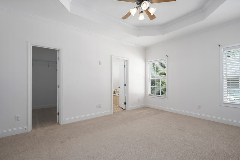 Primary bedroom with doors to the closet and bath