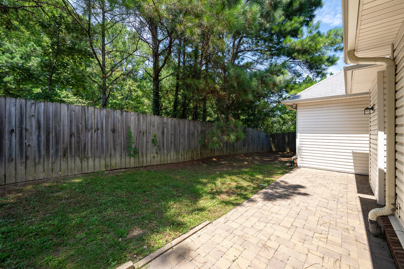 Paver patio along the back of the home