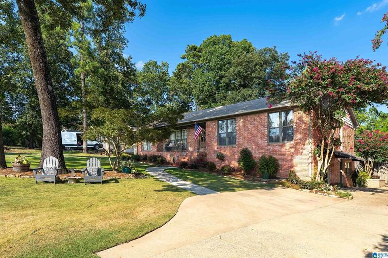 Curved driveway and front lawn with crepe myrtle