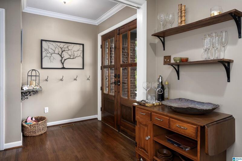 Entry hall with coat hooks and a wood bar cabinet