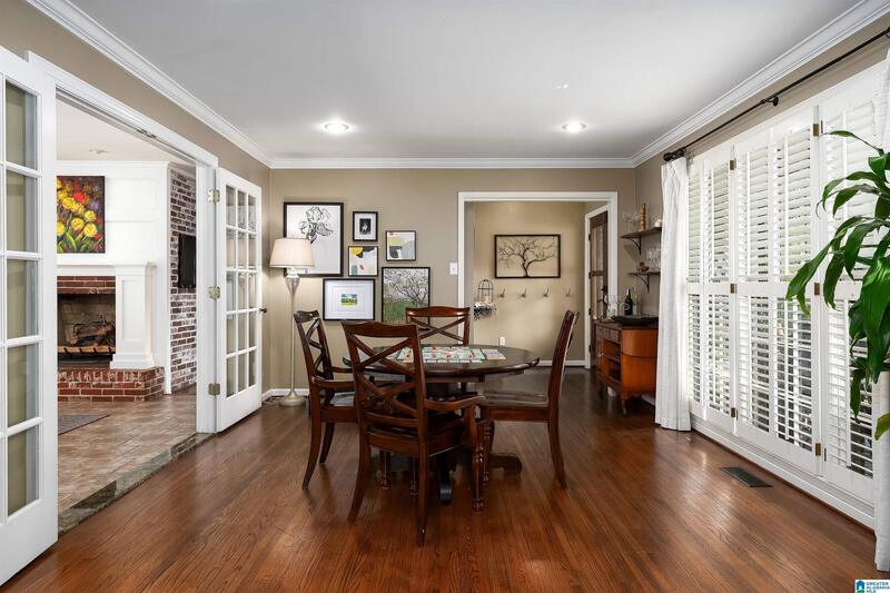 Dining area with French doors and the family room fireplace beyond
