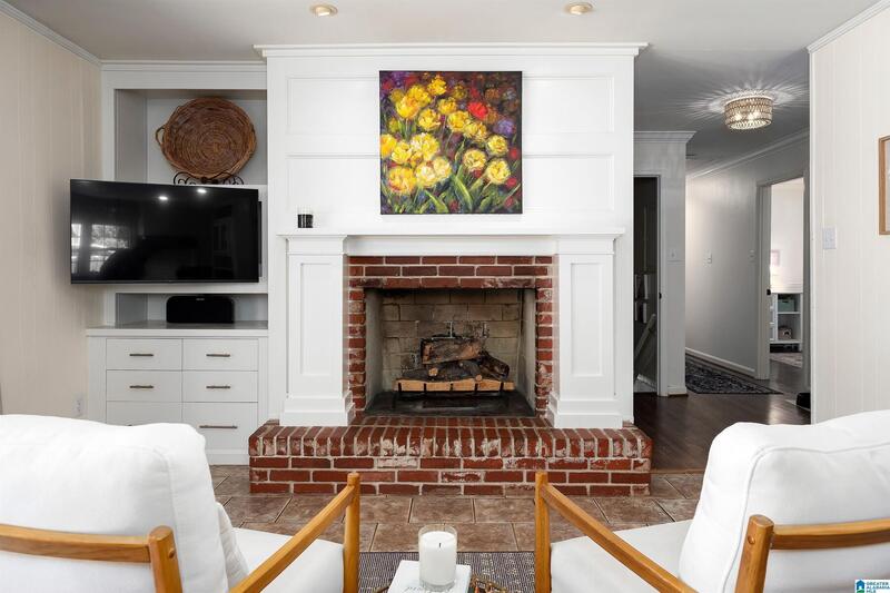 Brick fireplace with built-in cabinetry and gas logs
