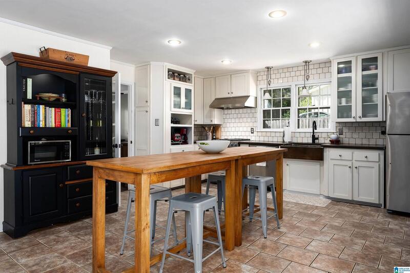 Kitchen with a wood island and subway tile backsplash