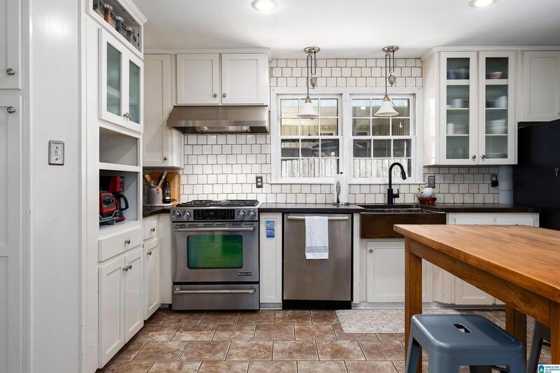 Kitchen with a gas range and white cabinets
