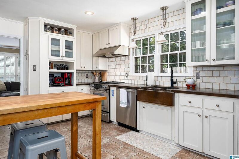 Kitchen with a farmhouse sink and glass-front cabinets