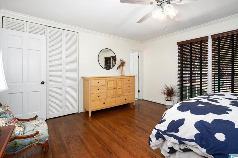 Primary bedroom with a dresser and closet doors