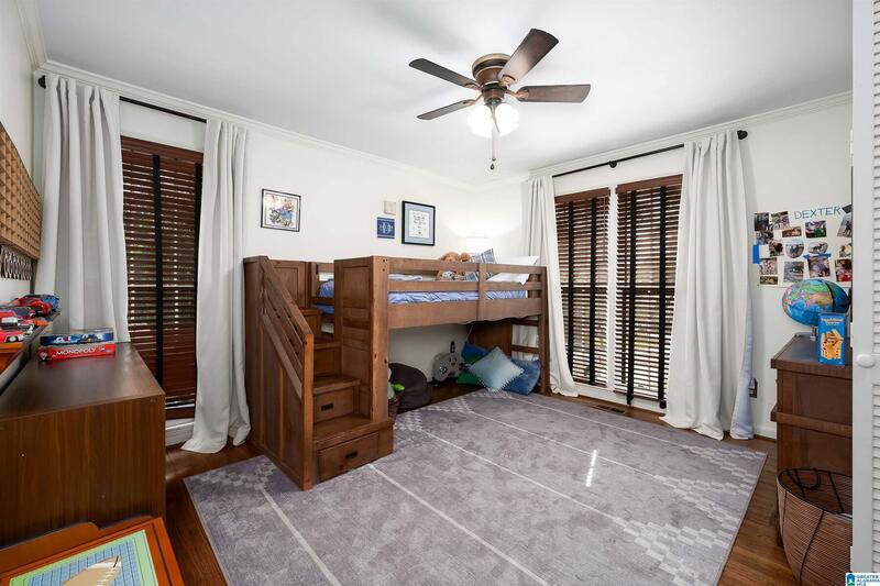 Bedroom with hardwood floors and large windows