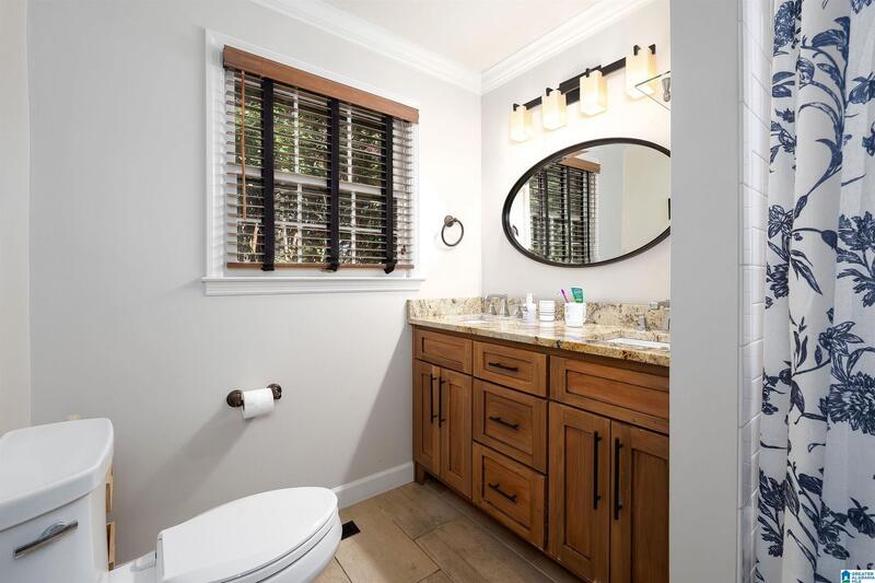 Hall bath with a wood vanity