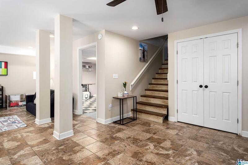 Basement den with a staircase and double doors